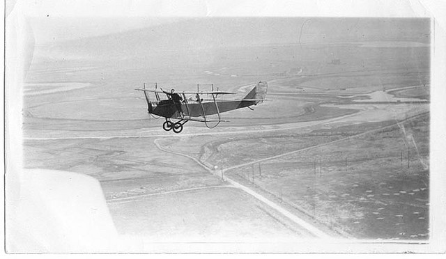 Charles P. Cooley on wing, over San Francisco peninsula by bay, out of San Carlos Airport; Sterling Price at controls Charles P. Cooley on wing, over San Francisco peninsula by bay, out of San Carlos Airport; Sterling Price at controls
