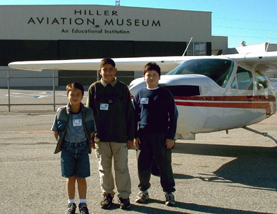 Young Eagles Collin Tsai, Anthony Kaveh and Kahn Paulsen prepare for their first ride in a light plane