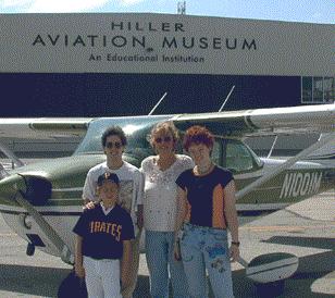 Nancy Stock poses with three Young Eagles following their first airplane rides