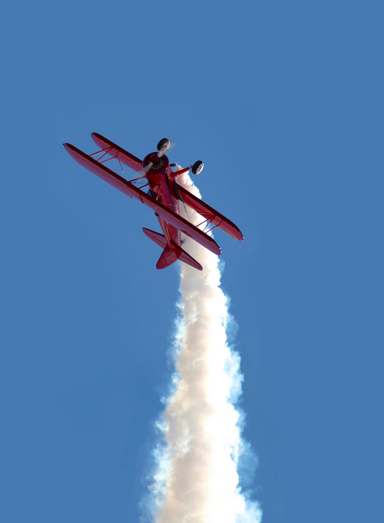 red_stearman_with_smoke